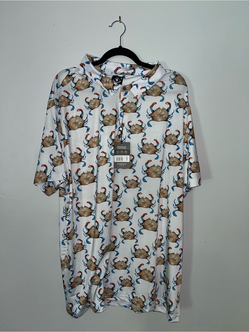 Raised By Coyotes Blue Crab Polo Shirt in white with blue & brown crabs